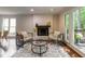 Bright living room with a fireplace and hardwood floors, complemented by a cozy seating area and large windows at 104 Silver Fox Ct, Cary, NC 27511