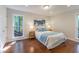 Comfortable main bedroom with wood floors, natural light, and serene decor at 104 Silver Fox Ct, Cary, NC 27511