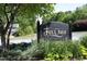 Community sign for Fox Chase features ornamental foliage and mature shade trees at 104 Silver Fox Ct, Cary, NC 27511