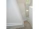 Carpeted staircase leading to the upper level of the home with white railing and natural light at 104 Silver Fox Ct, Cary, NC 27511