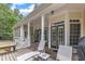 Spacious back porch with outdoor seating and elegant glass paneled doors at 106 Kenneil Ct, Apex, NC 27502