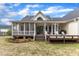 Expansive backyard featuring a spacious deck, screened porch, and mature trees at 106 Kenneil Ct, Apex, NC 27502