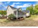 Charming backyard with a screened porch, patio, and lush landscaping at 106 Kenneil Ct, Apex, NC 27502