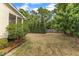 Expansive backyard featuring a mix of mature trees, garden beds, and partial fencing at 106 Kenneil Ct, Apex, NC 27502
