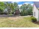 Spacious backyard with lush greenery, mature trees and a wooden fence line at 106 Kenneil Ct, Apex, NC 27502