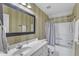 Bright bathroom showcasing a large mirror, white vanity, and shower/tub combination at 106 Kenneil Ct, Apex, NC 27502