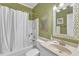 Traditional-style bathroom featuring a white vanity, framed mirror, and a shower with a curtain rod at 106 Kenneil Ct, Apex, NC 27502
