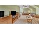 This carpeted attic bedroom features a ceiling fan, furniture, neutral walls, and a window with a wooded view at 106 Kenneil Ct, Apex, NC 27502