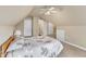 A carpeted bedroom offers neutral walls, a ceiling fan, and a window with white curtains at 106 Kenneil Ct, Apex, NC 27502