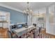 Spacious dining area with hardwood floors, large windows, stylish chandelier and furniture at 106 Kenneil Ct, Apex, NC 27502