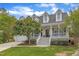 Inviting two-story home with a classic front porch, lush lawn, and a convenient two car garage at 106 Kenneil Ct, Apex, NC 27502