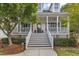 Close up of the house entrance showing the steps to the columned front porch with mature landscaping at 106 Kenneil Ct, Apex, NC 27502