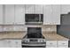 Close-up of range and microwave highlighting the modern stainless steel appliances at 106 Kenneil Ct, Apex, NC 27502