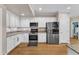 Fully equipped kitchen featuring stainless appliances, custom cabinetry, and granite countertops at 106 Kenneil Ct, Apex, NC 27502
