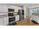 Well-equipped kitchen featuring stainless steel appliances, granite counters, and modern cabinets at 106 Kenneil Ct, Apex, NC 27502