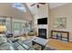 Bright living room featuring hardwood floors, a fireplace, large windows, and a vaulted ceiling at 106 Kenneil Ct, Apex, NC 27502