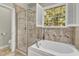 Main bathroom featuring an alcove tub and a glass shower at 106 Kenneil Ct, Apex, NC 27502