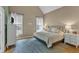 This relaxing main bedroom has a vaulted ceiling, lots of natural light and is decorated with neutral tones at 106 Kenneil Ct, Apex, NC 27502