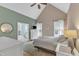 Main bedroom has vaulted ceiling, ensuite bath, lots of natural light and is decorated with soft neutral tones at 106 Kenneil Ct, Apex, NC 27502