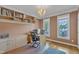 Bright office space with built-in shelves, hard wood floors, and a desk set up for two at 106 Kenneil Ct, Apex, NC 27502
