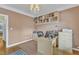 A home office offers built-in shelves, desk, and neutral walls over a hardwood floor and area rug at 106 Kenneil Ct, Apex, NC 27502