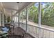 Relaxing screened porch area with wicker furniture and a view of the lush backyard at 106 Kenneil Ct, Apex, NC 27502