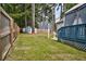 A spacious backyard featuring a well-maintained lawn, privacy fence, and a charming gazebo-covered deck at 1100 Brandywine Ln, Rocky Mount, NC 27804