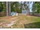 Large backyard with trees, a storage shed, and a wooden privacy fence at 1100 Brandywine Ln, Rocky Mount, NC 27804