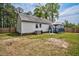 A serene backyard with a white home, small deck with gazebo, and some grass surrounded by fencing at 1100 Brandywine Ln, Rocky Mount, NC 27804