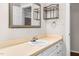 Bathroom with a white vanity, mirror, and convenient storage shelves at 1100 Brandywine Ln, Rocky Mount, NC 27804