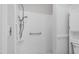 Bathroom featuring a tiled shower, safety bar, and storage at 1100 Brandywine Ln, Rocky Mount, NC 27804