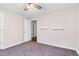 Carpeted bedroom featuring a ceiling fan, neutral walls, and closet at 1100 Brandywine Ln, Rocky Mount, NC 27804