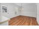 Bright dining area featuring white cabinets, wood-look flooring, and modern lighting fixtures at 1100 Brandywine Ln, Rocky Mount, NC 27804