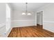 Bright dining room with wood-look flooring, white trim, and contemporary lighting fixtures at 1100 Brandywine Ln, Rocky Mount, NC 27804