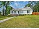 Charming single-story home featuring a welcoming front porch, brick foundation, and a well-manicured lawn at 1100 Brandywine Ln, Rocky Mount, NC 27804
