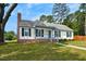 Classic one-story home with brick foundation and a chimney, complemented by a lush lawn and shady trees at 1100 Brandywine Ln, Rocky Mount, NC 27804