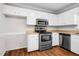 Kitchen with stainless steel appliances, white cabinets and tan countertops at 1100 Brandywine Ln, Rocky Mount, NC 27804
