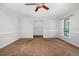 Well-lit living room offering views to the dining room with a decorative ceiling fan and neutral decor at 1100 Brandywine Ln, Rocky Mount, NC 27804