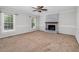 Bright and spacious living room with a decorative ceiling fan, cozy fireplace, and large windows at 1100 Brandywine Ln, Rocky Mount, NC 27804