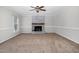 Spacious living room boasting a cozy brick fireplace and ample natural light from large windows at 1100 Brandywine Ln, Rocky Mount, NC 27804