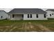 Back of house with large windows and new lawn, perfect for relaxing and entertaining at 115 Oakfield Trace Dr, Four Oaks, NC 27524