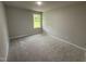 Cozy bedroom with plush carpet and large window offering ample natural light at 115 Oakfield Trace Dr, Four Oaks, NC 27524