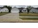 Lovely single-story home with gray siding, two-car garage, concrete driveway, and sidewalk at 115 Oakfield Trace Dr, Four Oaks, NC 27524