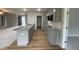 Modern kitchen with gray cabinets, granite countertops, and an open layout with natural light at 115 Oakfield Trace Dr, Four Oaks, NC 27524