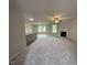 Open-concept living area featuring a kitchen bar, fireplace, and abundant natural light at 115 Oakfield Trace Dr, Four Oaks, NC 27524