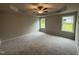 Expansive main bedroom with tray ceiling, fan, and natural light from multiple windows at 115 Oakfield Trace Dr, Four Oaks, NC 27524