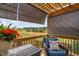 Cozy porch with retractable screens, flower pot, and blue armchair at 1202 Lexington Ridge Ln, Apex, NC 27502