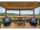 Covered back porch with outdoor furniture and peaceful view of the countryside at 1202 Lexington Ridge Ln, Apex, NC 27502