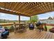 Covered back porch featuring wood table and chairs and a green egg grill at 1202 Lexington Ridge Ln, Apex, NC 27502