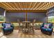 Back porch with outdoor seating, table set, and retractable sun shades at 1202 Lexington Ridge Ln, Apex, NC 27502